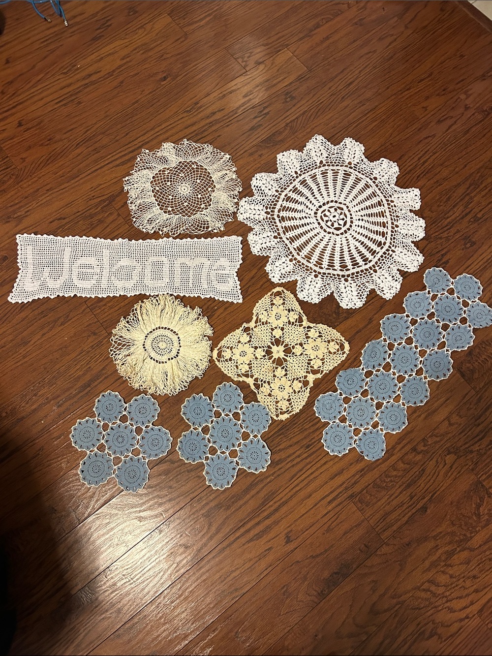 Handmade White and Blue Crochet Doily Set of 8. Some staining.